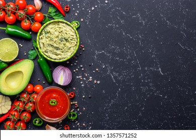 Traditional Mexican Latin American Salsa sauce and Guacamole and ingredients on black stone table. Top view copy space. - Powered by Shutterstock