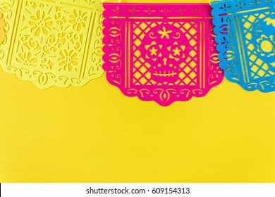 Traditional Mexican Papel Picado Paper Banner On A Wood Background.