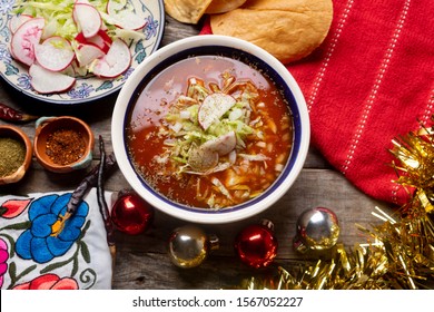 Traditional Mexican Red Pozole With Christmas Decoration On Wooden Background