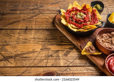 Traditional Mexican Refried Beans With Nachos, Jalapeno And Tomato Sauce. Wooden Background. Top View. Copy Space