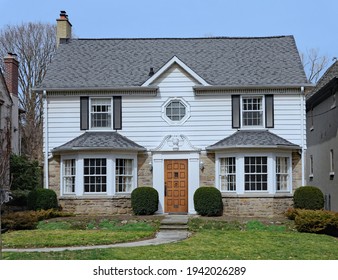 Traditional Middle Class Two Story House With White Siding On Upper Floor