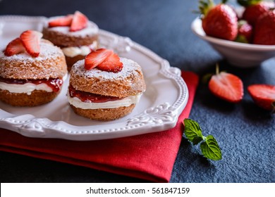 Traditional mini Victoria sponge cakes with whipped cream and strawberries - Powered by Shutterstock