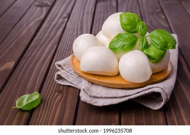 Traditional mozzarella cheese on a dark wooden background. Selective focus. - Powered by Shutterstock