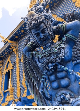 Traditional mythical wood sculpture of  Blue Temple or (Thai: Wat Rong Suea Ten) at Chiang Rai Thailand