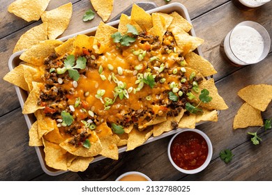 Traditional Nachos With Ground Beef, Cheddar Cheese And Red Pepper Served With Beer