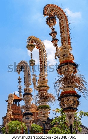 Traditional national Balinese decorations along the streets in Denpasar downtown.Tall bamboo poles with decoration are set in honour of hindu gods; cultural features of the island of Bali in Indonesia