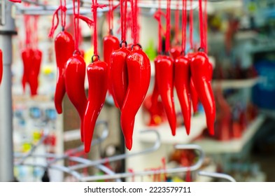 A traditional Neapolitan souvenir on the oudau - cornetto portafortuna. Red pepper or horn is one of the oldest mascots. Horizontal orientation. Selective focus.