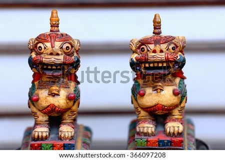 Traditional nepalese wooden carved snow lion figurines for sale in the windowshop of a souvenir store in the Thamel area-Kathmandu. Kathmandu district-Bagmati zone-Nepal.