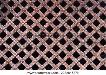 Traditional Nepali Wooden Window textured background, Wood Carved Wall or Ceiling Panel, pattern photography. Wooden window carved details on a Hindu temple. Ancient window texture.                   
