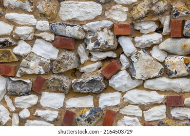 Traditional Norfolk Brick and Flint Wall. Close-up showing the abstract patten and colours.