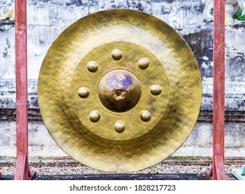 Traditional norhtern Thai style gold color gong hanging at the temple in Thailand