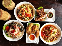 Traditional Northeastern Thailand Foods,  Many Variety Various Isaan Foods On A Wooden Table.