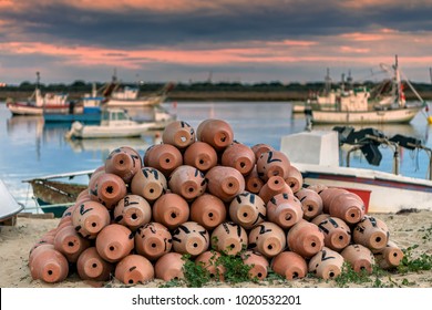 Traditional octopus traps in Puerto Umbria fishing port in Andalusia, Spain, at sunset; selective focus