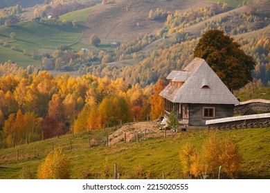 Traditional Old Architecture House Built In The Middle Of The Mountains From Romania. Beautiful Autumn Landscape On Rucar Bran Passage.