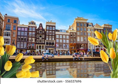 Traditional old buildings and and boats in Amsterdam, Netherlands. Canals of Amsterdam