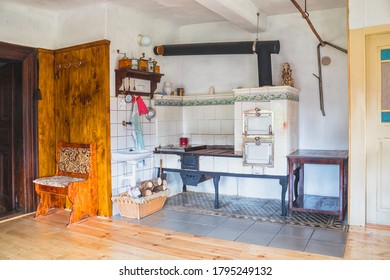 Traditional Old Kitchen In A Timbered Cottage With A Tiled Stove