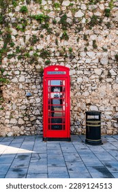 Traditional old red telephone booth in Gibraltar, UK