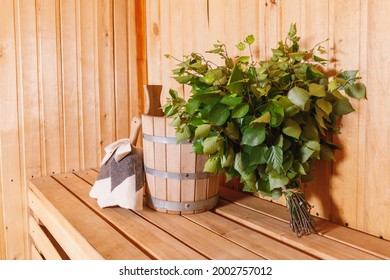 Traditional old Russian bathhouse SPA Concept. Interior details Finnish sauna steam room with traditional sauna accessories basin birch broom scoop felt. Relax country village bath concept.