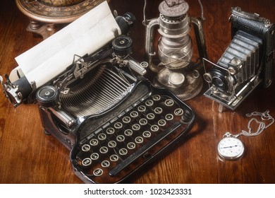 Traditional and old way of writing messages and taking photos, typewriter, camera, watch, pen, Vintage lamp on the desk