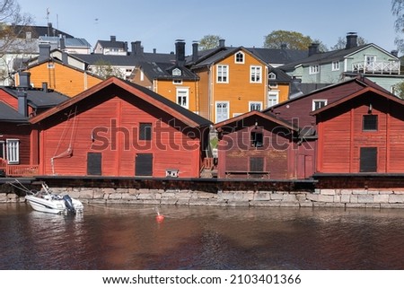 Traditional old wooden houses and barns stand along the river coast, historical part of Porvoo town, Finland