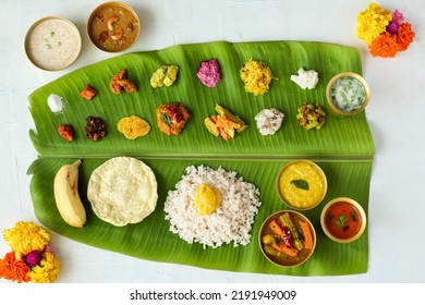 Traditional Onam sadhya rice Sambar, Rasam, parippu dal curry ghee Pappadom Payasam on banana leaf Onam Vishu Pongal Diwali festival vegetarian food Kerala Tamil Nadu South India. - Shutterstock ID 2191949009