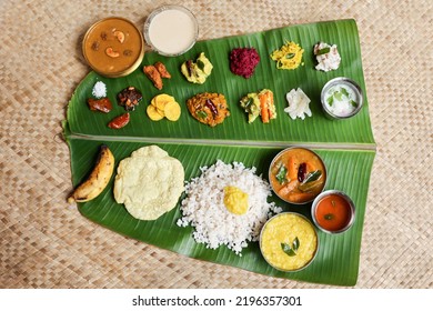 Traditional Onam sadhya rice Sambar, Rasam, parippu dal curry ghee Pappadom Payasam on banana leaf Onam Vishu Pongal Diwali festival vegetarian food Kerala Tamil Nadu South India. - Shutterstock ID 2196357301