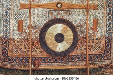 Traditional oriental gong on a beautiful ornamental background.