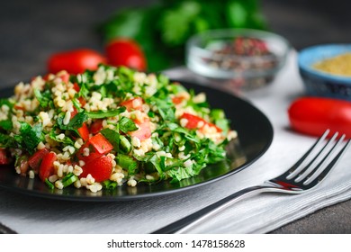 Traditional oriental salad Tabouleh with bulgur and parsley on a dark background. - Shutterstock ID 1478158628
