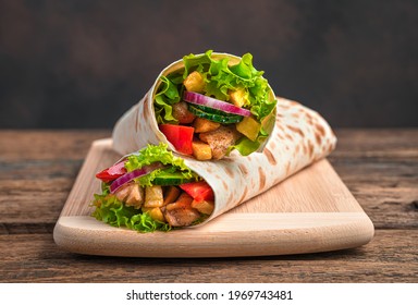 Traditional oriental shawarma close-up on a brown background. Side view, copy space.