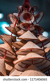 Traditional Oriental Straw And Bamboo Hats, Piled Up Ready For Packaging And Worldwide Shipping.