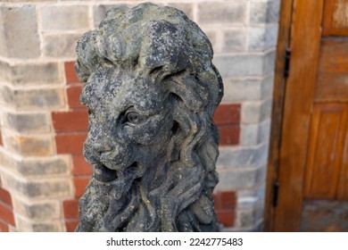 Traditional ornamental statue depicting a sitting lion, within a public park in the UK. - Shutterstock ID 2242775483
