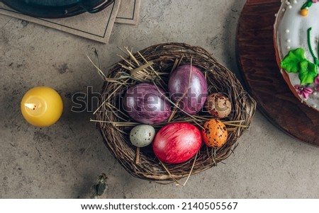 Traditional Ortodox Easter background. Easter eggs in a nest on a stone background.