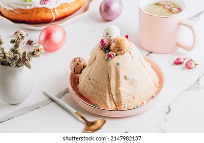Traditional Ortodox Easter curd cake on white marble background. Easter curd cake, Easter kulich and colored eggs. Selective focus