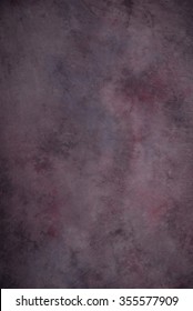Traditional painted canvas or muslin fabric cloth studio backdrop or background, suitable for use with portraits, products and concepts. Dark purples with hints of magenta.