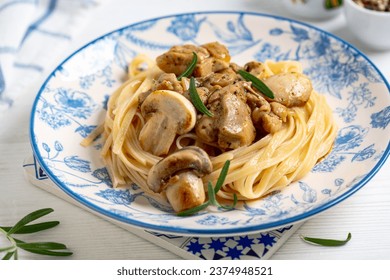 Traditional pasta (linguine) with mushrooms and cream sauce close up. Concept of homemade Italian cuisine. - Powered by Shutterstock