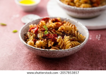 Traditional pasta with red pesto and sun dried tomatoes
