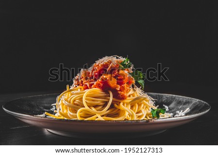 Traditional pasta spaghetti bolognese in plate on black wooden table background