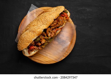 Traditional philly cheese steak with bell pepper on dark background