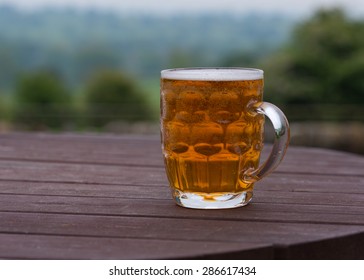 Traditional Pint Of Bitter Beer On Country Pub Beer Garden Table