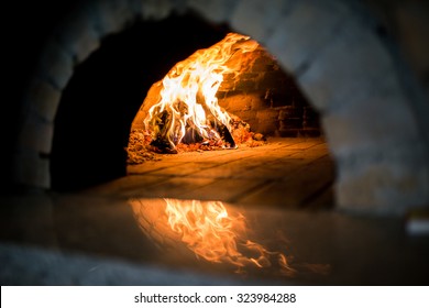 Traditional Pizza oven, burning wood and flames in fireplace 