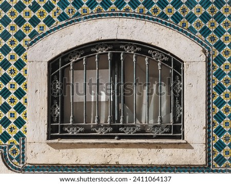 Traditional Portuguese architecture. Old abandoned house with window and exterior wall with colorful ceramic tiles Azulejo. Vintage facade in Portugal.