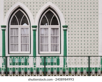 Traditional Portuguese architecture. Old house with white arched windows and exterior wall with green ceramic tiles. Vintage facade in Portugal. - Powered by Shutterstock