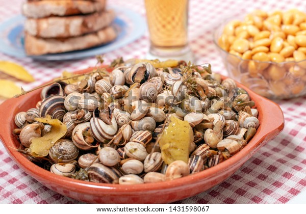 Traditional Portuguese dish of cooked snails and\
toasted bread and\
beer.