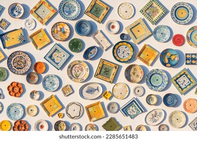Traditional portuguese pottery, local handcrafted products from Portugal. Wall of ceramic plates in Portugal. Colorful vintage ceramic plates in Sagres, Algarve, Portugal.