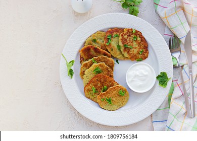 Traditional Potato Pancakes Made From Raw Potatoes On A White Plate On A Light Background Concrete. Belorussian Cuisine. Potato Recipes. Served With Sour Cream.