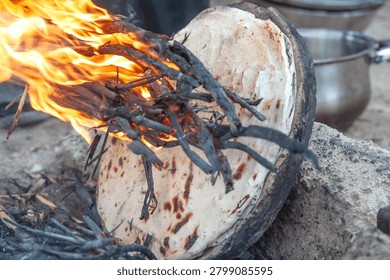 The traditional practice of making rice bread using an open fire in a local village in the Southern Marshes of Iraq, home to the Marsh Arabs also known as The Ma’dan, Middle East. 