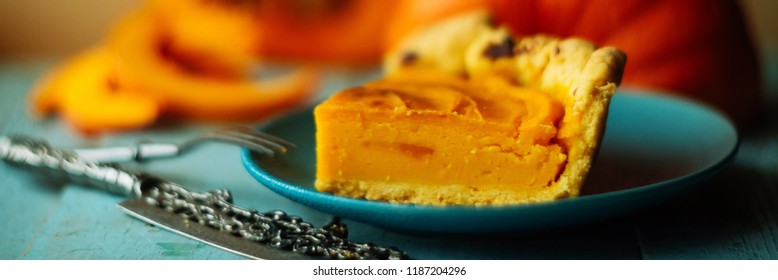 Traditional pumpkin pie preparation with filling, dough and ingredients on dark rustic background, top view, retro styled, frame