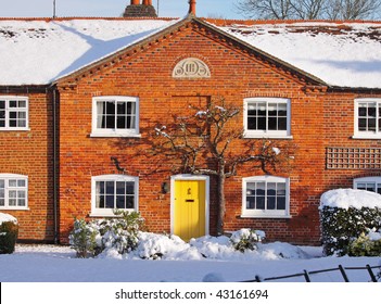 Traditional Red Brick English Village Terraced Cottage In The Snow