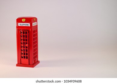 Traditional red London phone miniature on white background