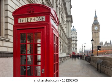 Traditional red telephone box in London public phone - a symbol of the city. Fragment of booths with the Big Ben in the background of the evening - Powered by Shutterstock